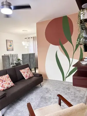 a living room with a couch and a painting on the wall at Apartment near the airport in Boca Chica