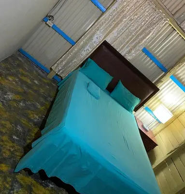 a bedroom with a blue bed in a room at the Count of Villa Rosa in La Ceiba