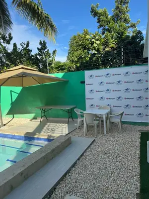 a picnic table and chairs next to a swimming pool at Villa yaya 1 in Boca Chica