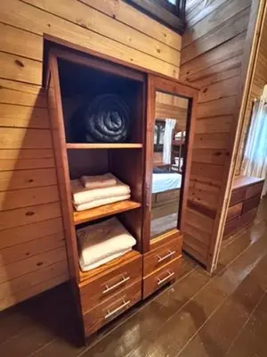 a room with a wooden cabinet with towels in it at Blue Lagoon House RD