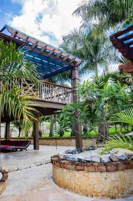 a wooden bridge over a fountain in a garden at Blue Lagoon House RD