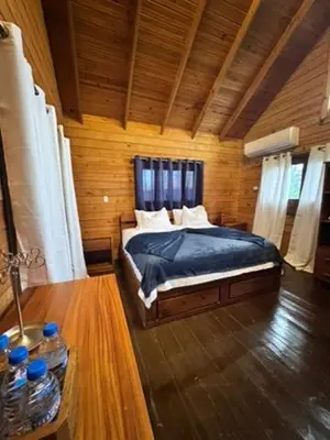 a bedroom with a bed in a wooden room at Blue Lagoon House RD