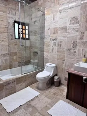 a bathroom with a toilet and a shower and a sink at Blue Lagoon House RD
