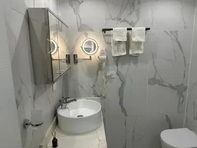 a white bathroom with a sink and a mirror at Beachfront - Stunning View in Boca Chica