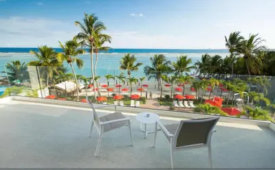 a balcony with a view of the beach and the ocean at Beachfront - Stunning View in Boca Chica
