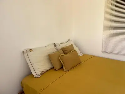 a bed with three pillows on it in a room at Casa La Loma En Las Galeras in Colorado