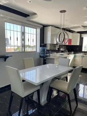 a kitchen with a white table and chairs at Bella casa en lo alto in El Seis