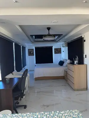 a bedroom with a large bed and a desk and a desk at Bella casa en lo alto in El Seis