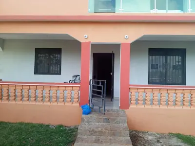 a house with a balcony with a ladder in the doorway at Casa Ramona in Las Galeras