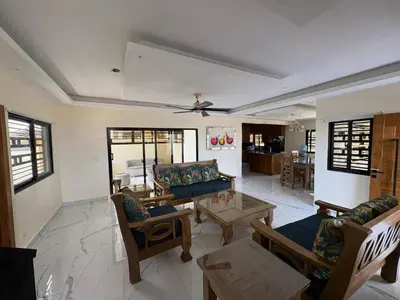a living room with a couch and a table at Villa Sol Odalis in Jarabacoa