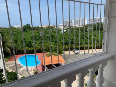 a balcony with a view of a swimming pool at Apartamento en Gribi in Juan Dolio