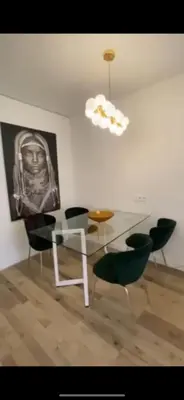 a dining room with a glass table and chairs at Sirius apartment in Santo Domingo