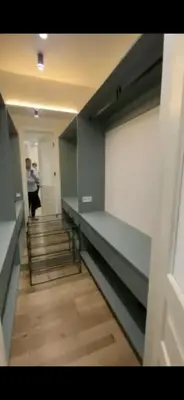a hallway with stairs and a person in a building at Sirius apartment in Santo Domingo