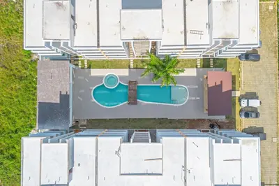 an aerial view of a building with a swimming pool at Chic Bayahibe 2BR in Sunshine near Bayahibe Center in Bayahibe