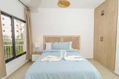 two swans towels on a bed in a bedroom at Chic Bayahibe 2BR in Sunshine near Bayahibe Center in Bayahibe
