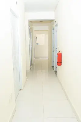 an empty corridor of a hospital with a red fire extinguisher at Hotel cotubanama