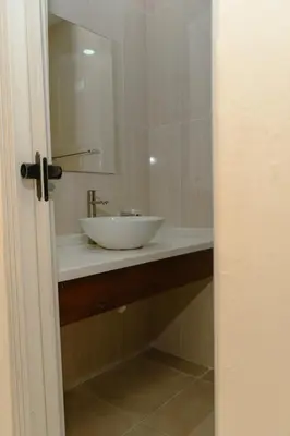 a bathroom with a white sink and a mirror at Hotel cotubanama