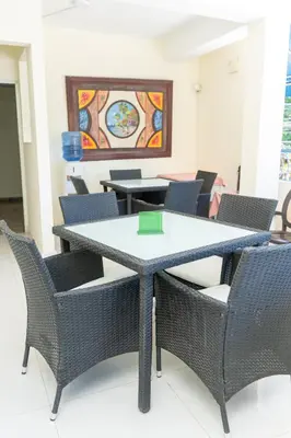 a table and chairs in a room with a painting at Hotel cotubanama