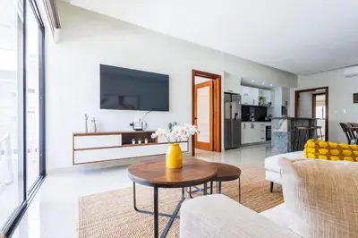 a living room with a couch and a table at 2BR Tropical Escape - Private Terrace, BBQ, Pool, Walk to Beach in Punta Cana