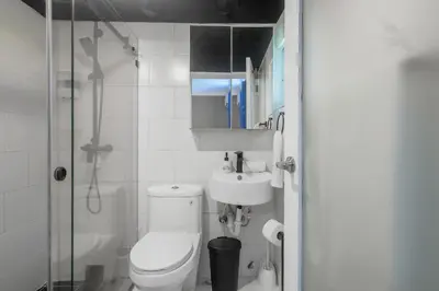 a bathroom with a toilet and a sink and a shower at Resort Villas | 2 hab con piscina y playa in Juan Dolio