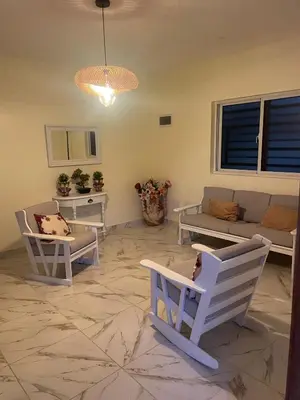 a living room with two chairs and a couch at res Montesino in San Felipe de Puerto Plata