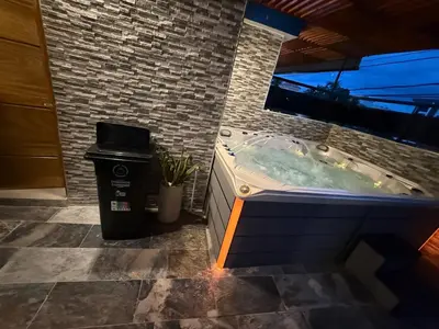 a jacuzzi tub in a bathroom with a trash can at private property just for you in San Isidro