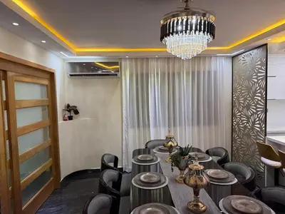 a dining room with a table and a chandelier at private property just for you in San Isidro