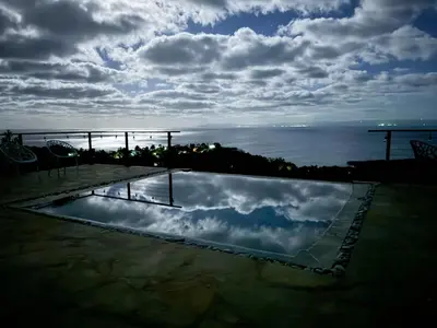 a reflection of the sky in a swimming pool at AguaSanta, Breeze & Views in Palmarito