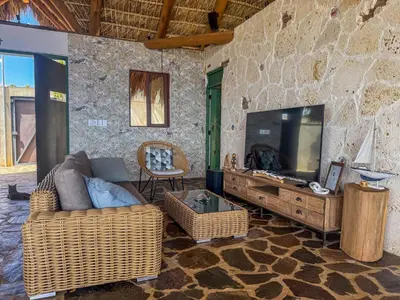 a living room with a tv and a couch and a table at AguaSanta, Breeze & Views in Palmarito