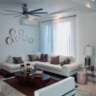 a living room with a white couch and a table at Crown 1 in Puerto Plata