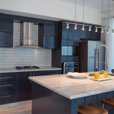 a kitchen with blue cabinets and a marble counter top at Crown 1 in Puerto Plata