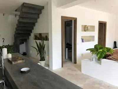 a living room with a table and a staircase at Beautiful Caribbean Villa Coson Beach in Las Terrenas