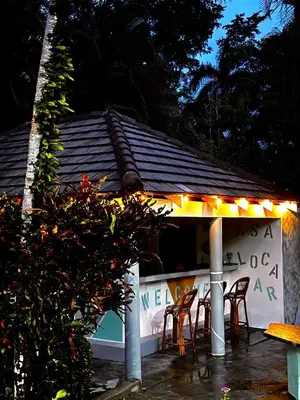 a table and chairs in front of a building at CasaLoca Cabarete Studio Apartment in Cabarete