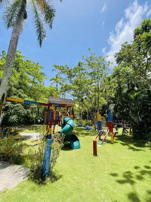 a playground with a slide in a park at Stylish 1BR, Pools & Walk to Beach - Sublime in Las Terrenas