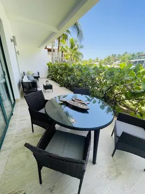 a dining table and chairs on a patio at Stylish 1BR, Pools & Walk to Beach - Sublime in Las Terrenas