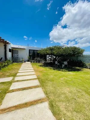 a pathway leading to a house with a grass yard at 2BR Getaway Villa in Montecristi in San Fernando de Monte Cristi
