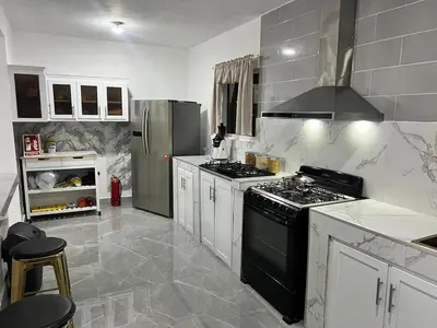 a kitchen with a stove and a refrigerator at Villa Medrano Home in Punta Cana