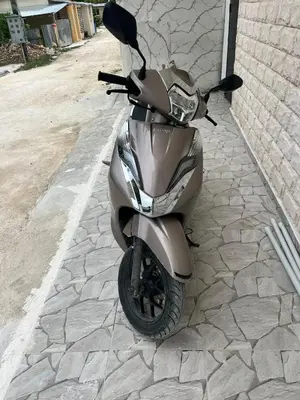 a motor scooter parked on the side of a street at Villa Medrano Home in Punta Cana