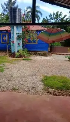 a building with an umbrella in front of it at Las Amapolas, Saman typical houses in Las Galeras