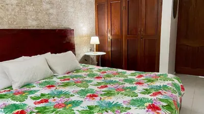 a bedroom with a bed with a floral bedspread at Sea Near and Beach a few minutes walking Top Location by RHV Living in San Felipe de Puerto Plata
