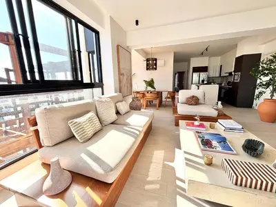 a living room with a couch and a table at Casita Coco - Luxury Apartment in Santiago in Santiago de los Caballeros