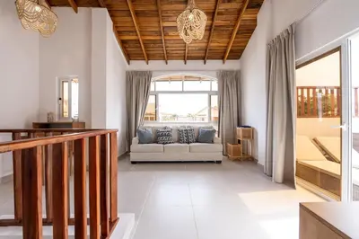 a living room with a couch and a window at Armonía Las Terrenas in Las Terrenas