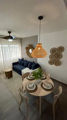 a living room with a table and a blue couch at Modern, Comfortable, Close to Beaches in Colorado