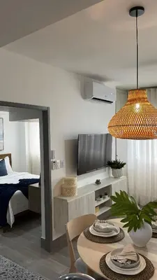 a living room with a bed and a dining room table at Modern, Comfortable, Close to Beaches in Colorado
