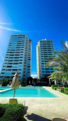 two large apartment buildings with a pool and an umbrella at Modern, Comfortable, Close to Beaches in Colorado