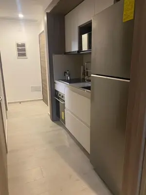 a kitchen with a stainless steel refrigerator and a wooden floor at Playa Matilde, apartamento de lujo in Punta Cana