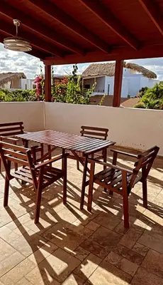 a picnic table and two benches on a patio at Hermosa villa familiar in Colorado