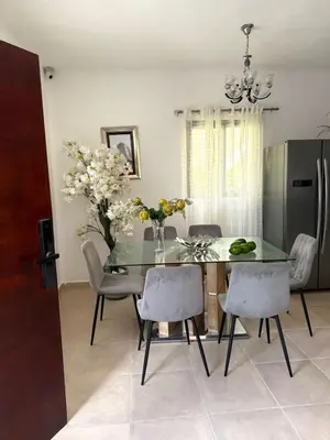 a dining room with a glass table and chairs at Hermosa villa familiar in Colorado