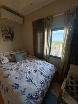 a bedroom with a bed and a window at Juan dolio Penthouse, beach access 3BR Salitre Tower front of Club Hemingway in Juan Dolio