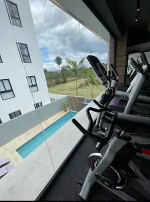 a gym with a view of a swimming pool at Residenza in Santiago de los Caballeros